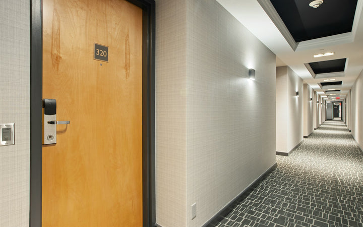 Hotel room door in a tiled corridor