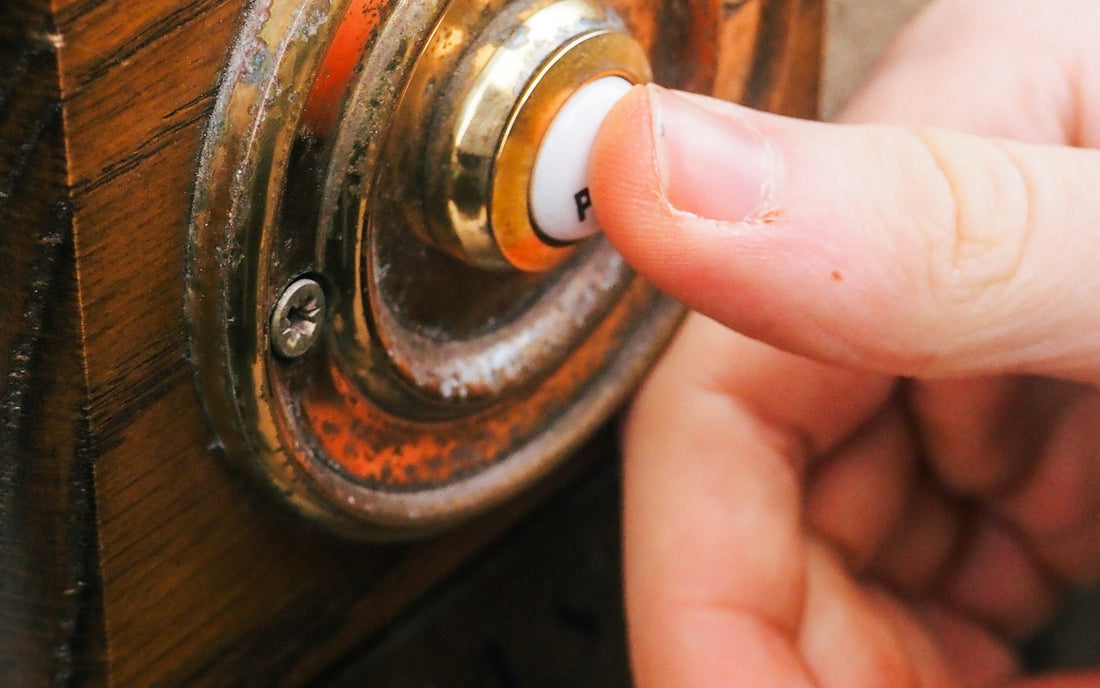 Visitor pressing a video doorbell
